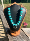 Turquoise-color black-and-white handmade statement necklace with floral focal.