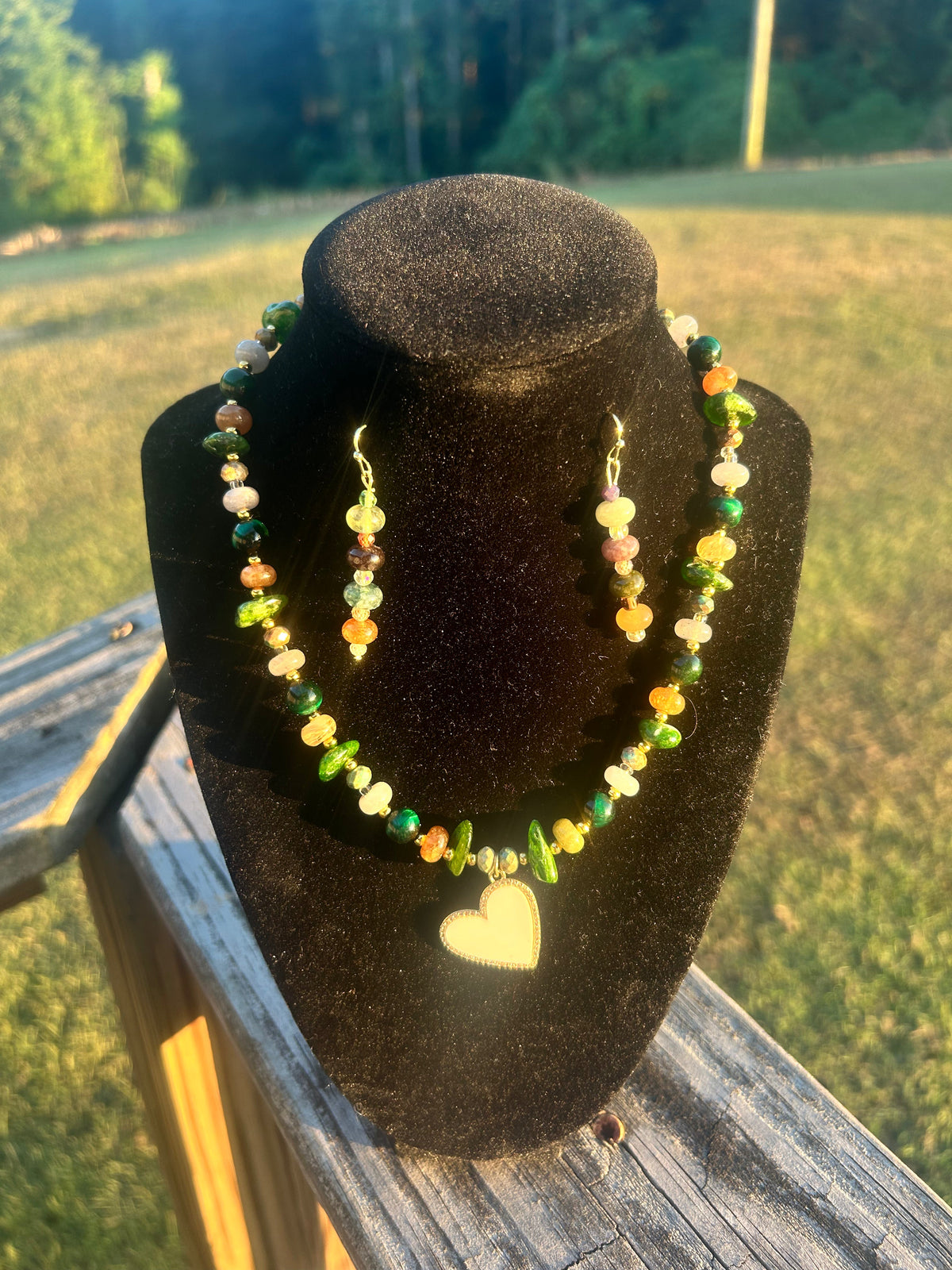 Green handmade beaded necklace and earring set with heart focal.