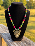 Jewel tone faceted bead necklace with gold leopard pendant