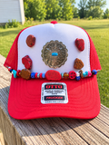 Red and white handmade Western trucker hat with silver-tone concho, stone accents and colorful beaded hat chain